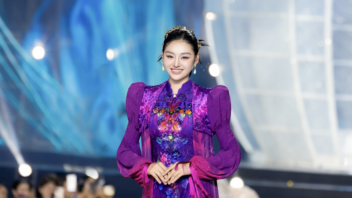 Mademoiselle Yen Nhi rayonne dans une robe traditionnelle vietnamienne ornée de quatre motifs de fleurs en soie.