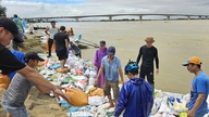 Thousands of people 'repaired embankments' to prevent historic floods and save villages downstream of the Thu Bon River.