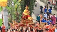 De lokale ser ivrigt på processionen med den "levende konge og dronning" ved Sai-tempelfestivalen.