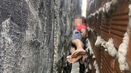 A boy was rescued just in time after being trapped between two walls.
