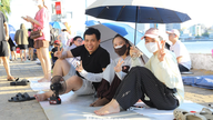 Spread out mats, set up tarpaulins, bring food to 'reserve' a spot to watch the fireworks in Da Nang.
