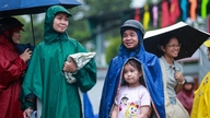 Menerobos hujan, para orang tua dengan sabar menunggu anak-anak mereka menyelesaikan ujian kelas 10.
