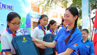 Volunteers in blue shirts focus on supporting digital transformation.