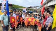 The Vietnamese coast guard stands alongside the fishermen.