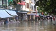 Local flooding due to heavy rain; residents take proactive measures to ensure their safety.