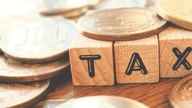 Is land auctioned to settle bad debts subject to value-added tax?