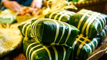 ភ្ញៀវទេសចរលោកខាងលិចរុំបាញ់ជុង (នំបាយប្រពៃណីវៀតណាម) រាំរបាំសាប និងវាយកំសៀវដីឥដ្ឋនៅលើឆ្នេរខ្សាច់ក្នុងទីក្រុងដាណាង។