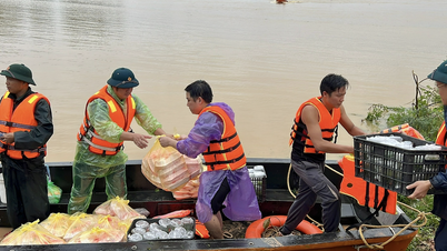 Road to Nam Tong village: Touching image of people working together to push relief carts through mud