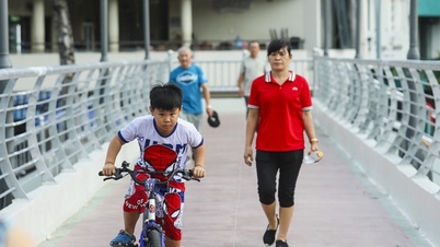 People enjoy experiencing the most beautiful pedestrian bridge across the canal in Ho Chi Minh City