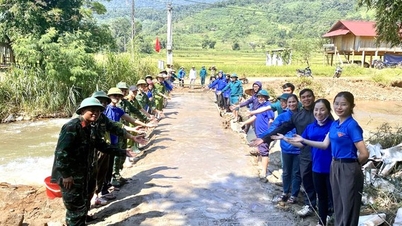 Young people pour concrete to make a bridge to cross the flood for students to go to school