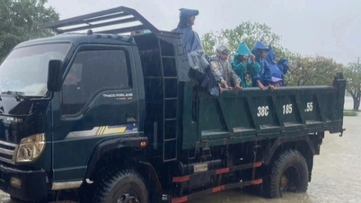 Parents use trucks and boats to carry their children home in heavy rain