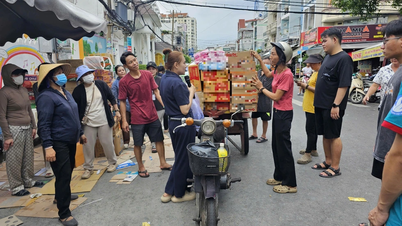 Woman selling vegetables carries full load of relief goods to send to people in Central Vietnam
