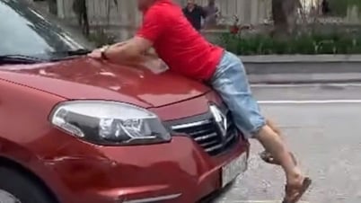 Aufwühlender Clip eines Mannes, der sich in Ha Tinh City an die Front eines fahrenden Autos klammert