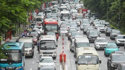 Traffic jam on the road, lane dividers are set up, cars "take over the path" of motorbikes