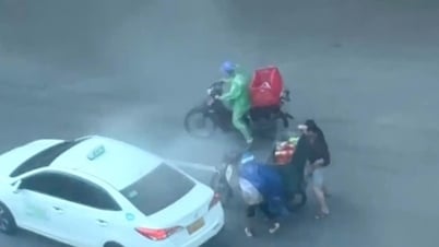Bất chấp mưa bão, người đàn ông băng ra giúp hai người ngã xe trên đường Phan Đình Phùng