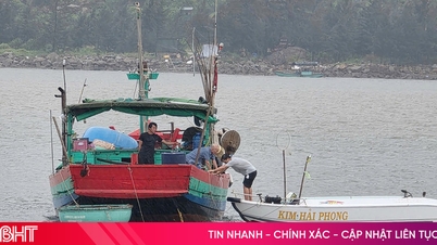 Fishermen brace boats in the rain before the storm hits