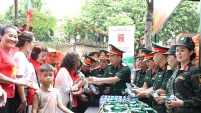 Tentara membagikan ransum kering dan abon ayam kering kepada orang-orang yang menonton parade.