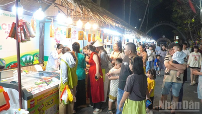 Un ambiente animado en el espacio de exposición de productos de OCOP, donde se exhiben productos característicos de la región del Delta del Mekong.