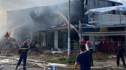 Police used a crane to break through the corrugated iron wall and bring the fire and explosion at the building materials store under control.