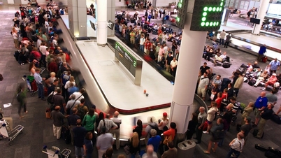 Why are many passengers disliked for standing close to the baggage claim area at the airport?