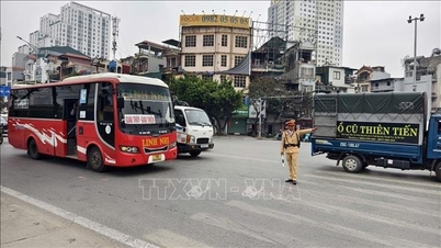 Traffic police escort and assist convoys of vehicles returning home for Tet (Lunar New Year).