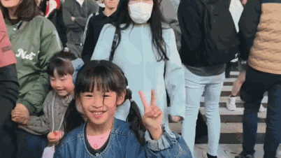 Outrage over girl being pushed down while taking photos at a Japanese intersection.