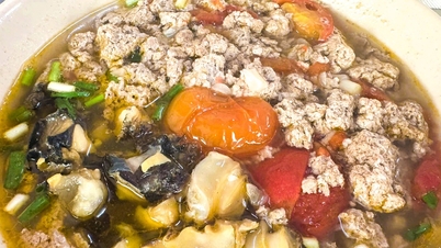 Traditional Hanoi-style crab noodle soup: Crab paste, tomatoes, and a little bit of fat.