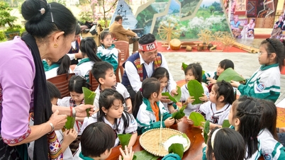 Nghe An: Basisschoolleerlingen oefenen enthousiast met het inpakken van cakejes in de vorm van buffelhoorns en het schrijven van wensen in het Thaise schrift.