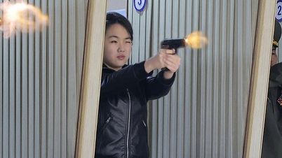 Kim Jong Un and his daughter test a gun at a weapons factory.