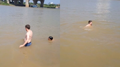 Lo straniero, pur rilassandosi in un caffè, non resistette al caldo di Hanoi e scese al fiume Duong per fare una nuotata.