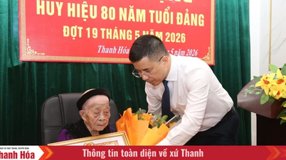 Entrega de la insignia por 80 años de militancia en el Partido a Dong Thi Dai, miembro del Partido.