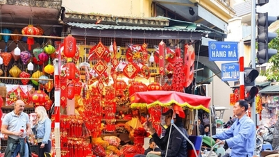 Hanoi: A Hang Ma utca, amely a korai Tet ünnep élénkpiros színeiben pompázik, vonzza a nyugati turistákat.